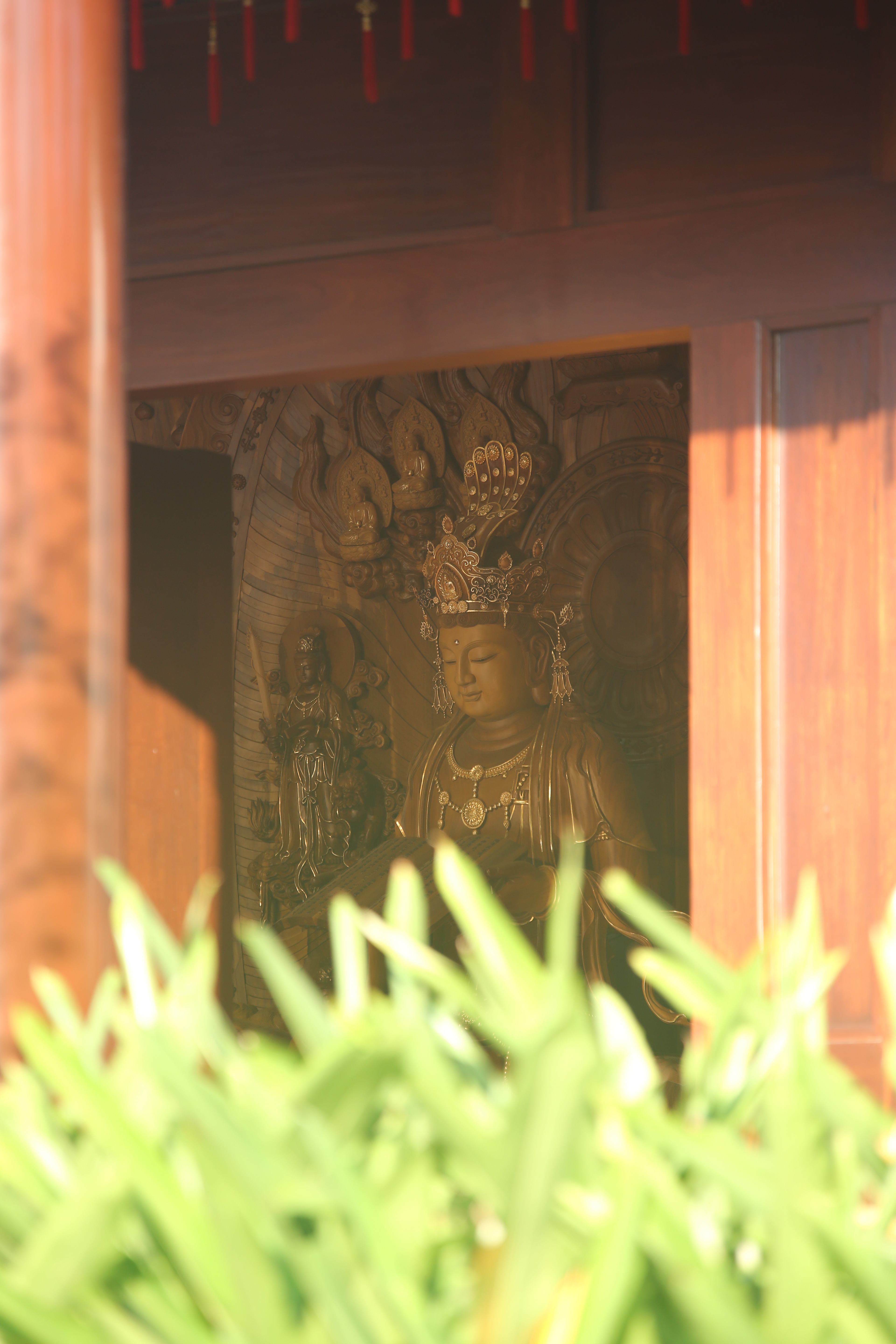 Golden Bodhisattva through temple doorway