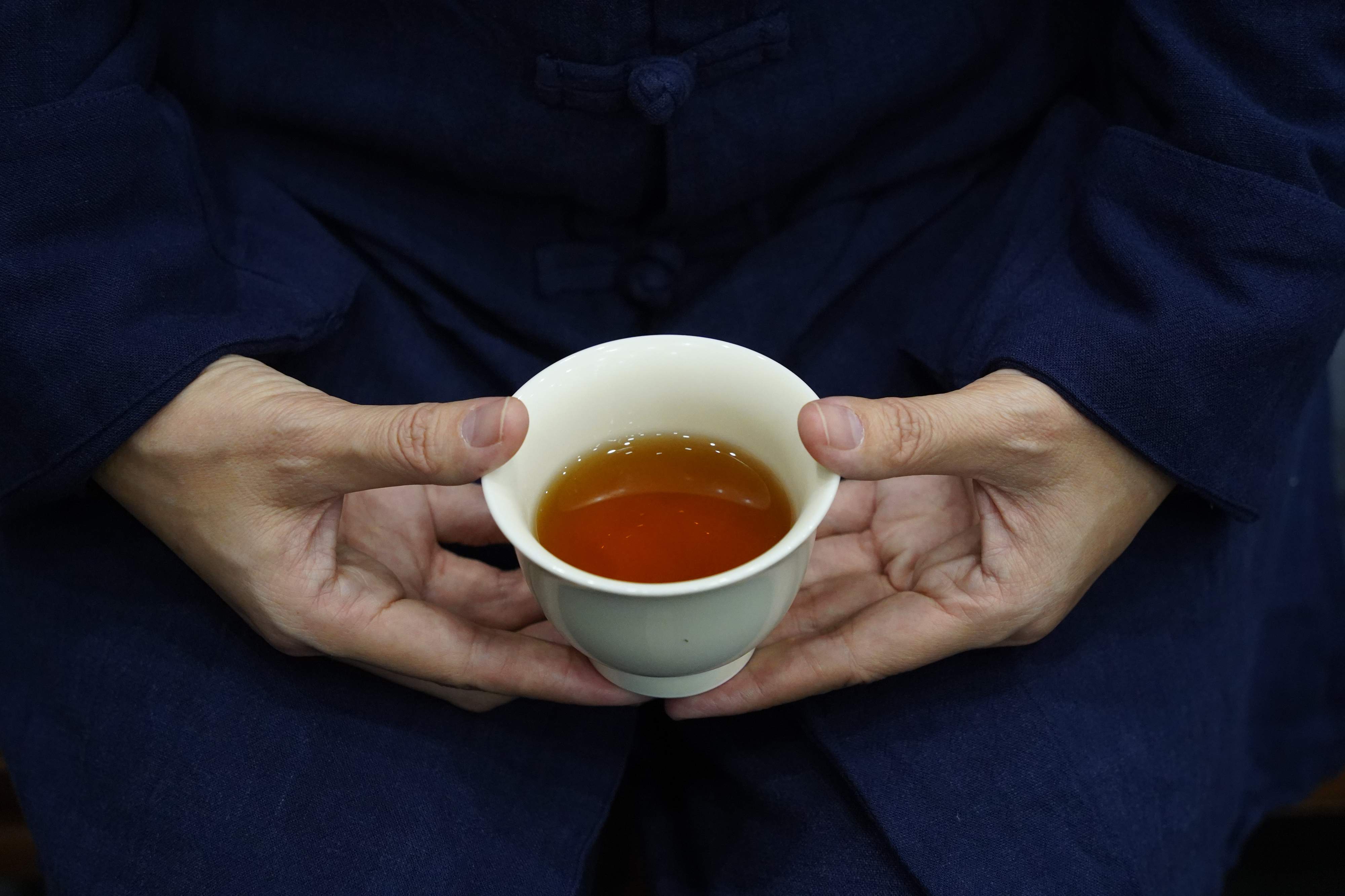 Hands holding tea cup